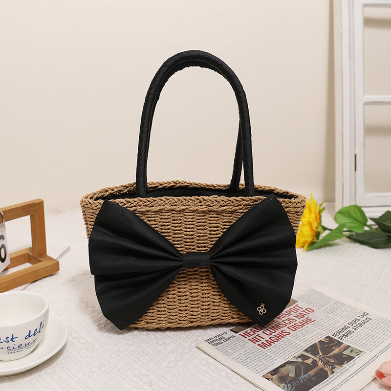 Bolso de mano tejido de paja con lazo bohemio