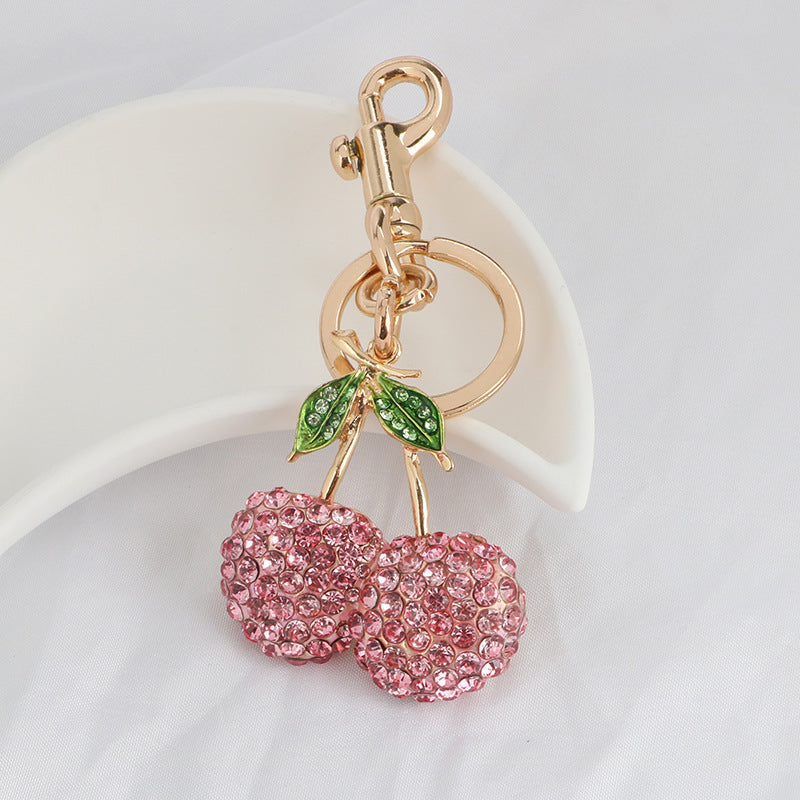 Llavero con colgante de cereza y diamantes de imitación rosas para mujer