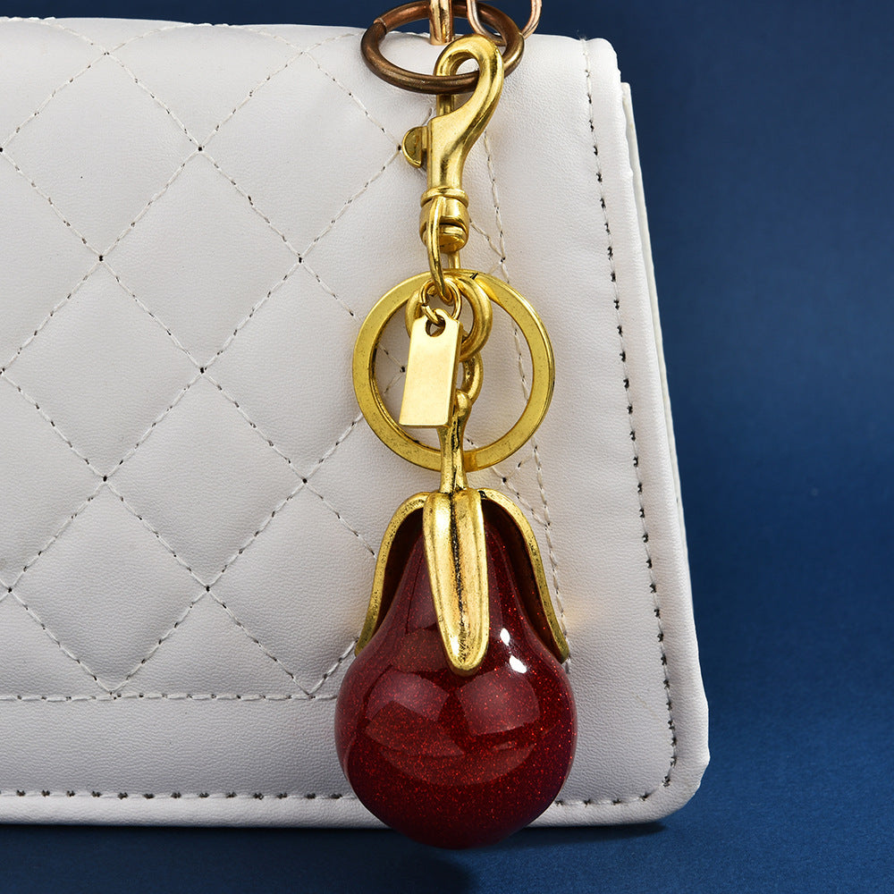 Llavero con colgante de pera dorada a la moda para mujer