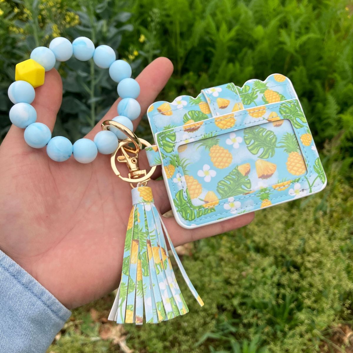 Cartera con pulsera y borlas de silicona estampadas a la moda