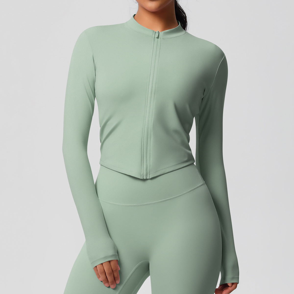Top deportivo de manga larga de color liso a la moda para mujer