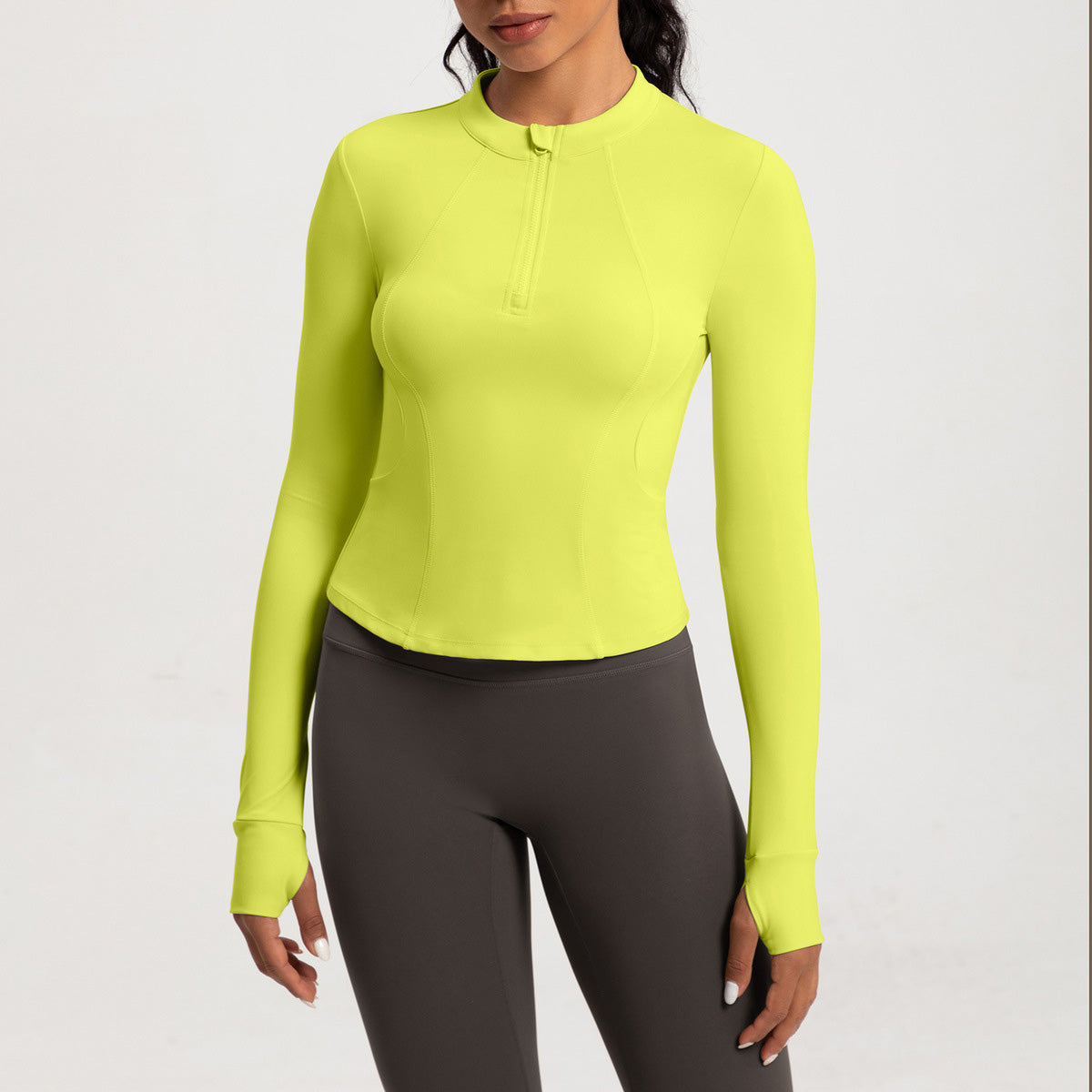 Top de yoga de manga larga con media cremallera de color liso a la moda para mujer