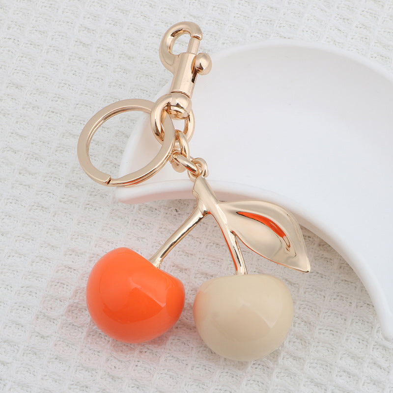 Llavero con colgante de resina con forma de cereza para bolso de mujer