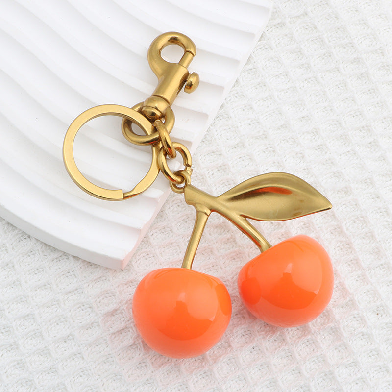 Llavero con colgante de resina con forma de cereza para bolso de mujer