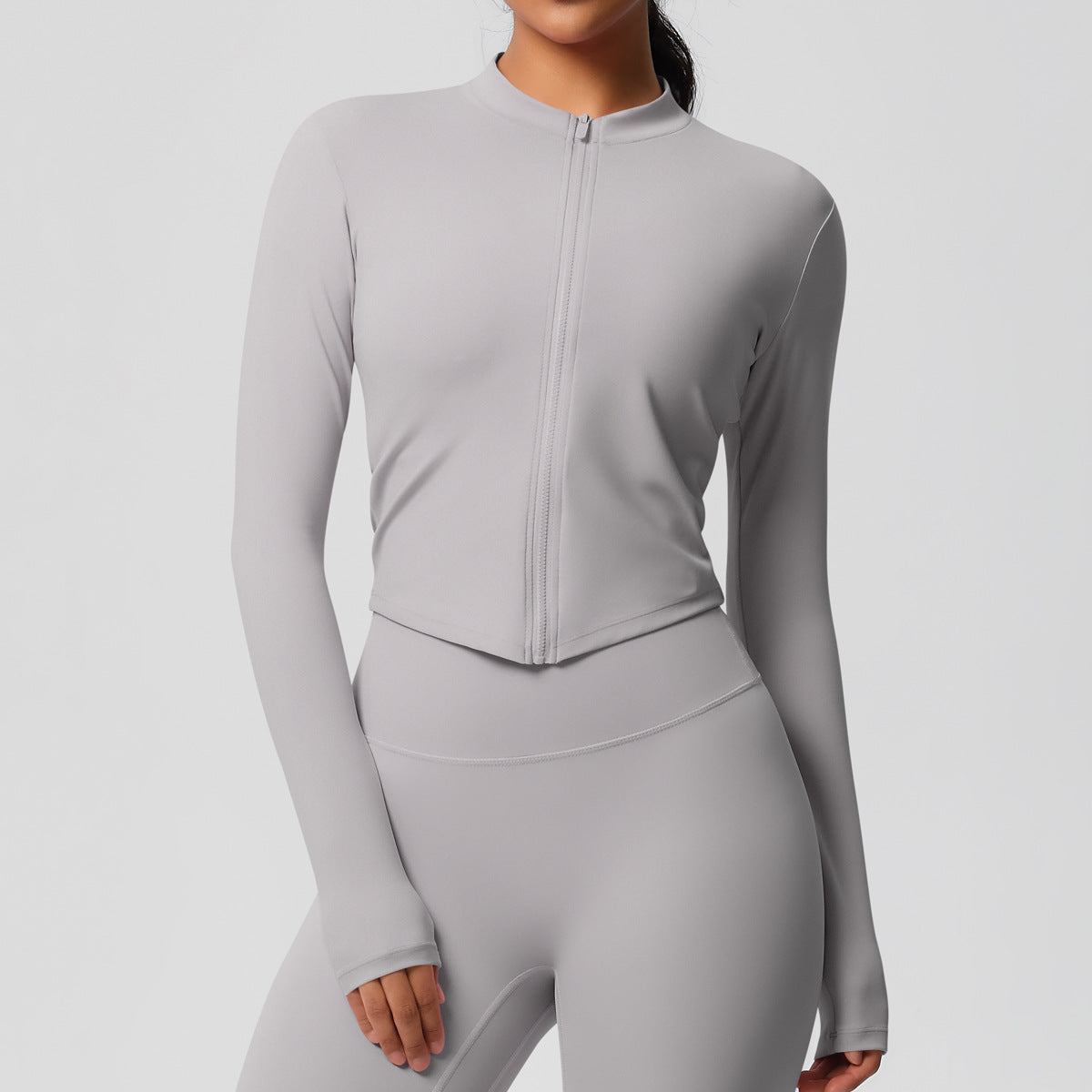 Top deportivo de manga larga de color liso a la moda para mujer