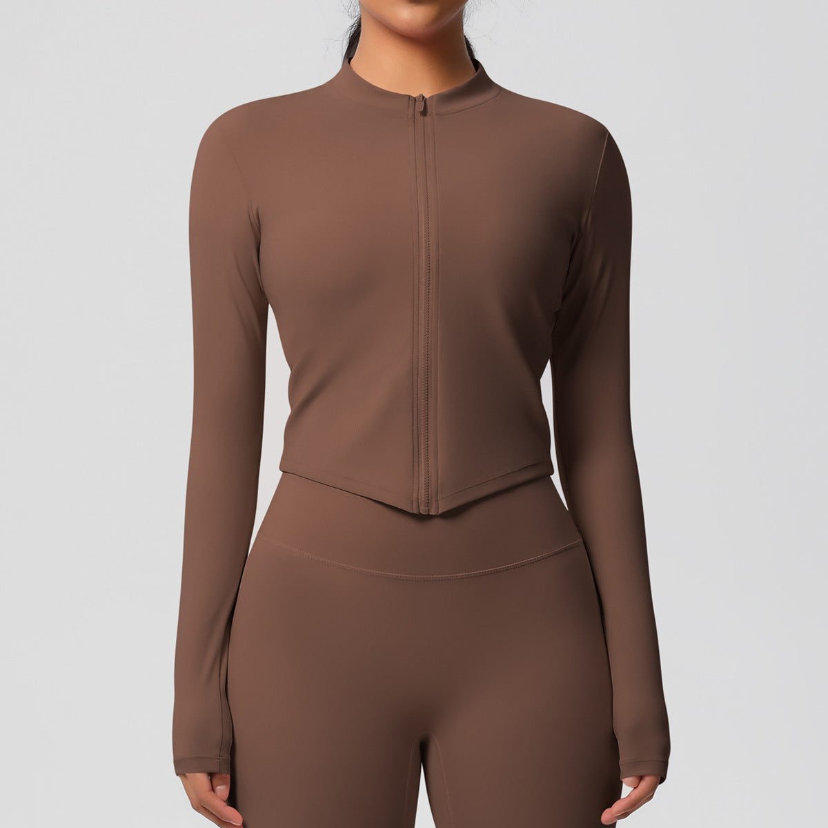 Top deportivo de manga larga de color liso a la moda para mujer