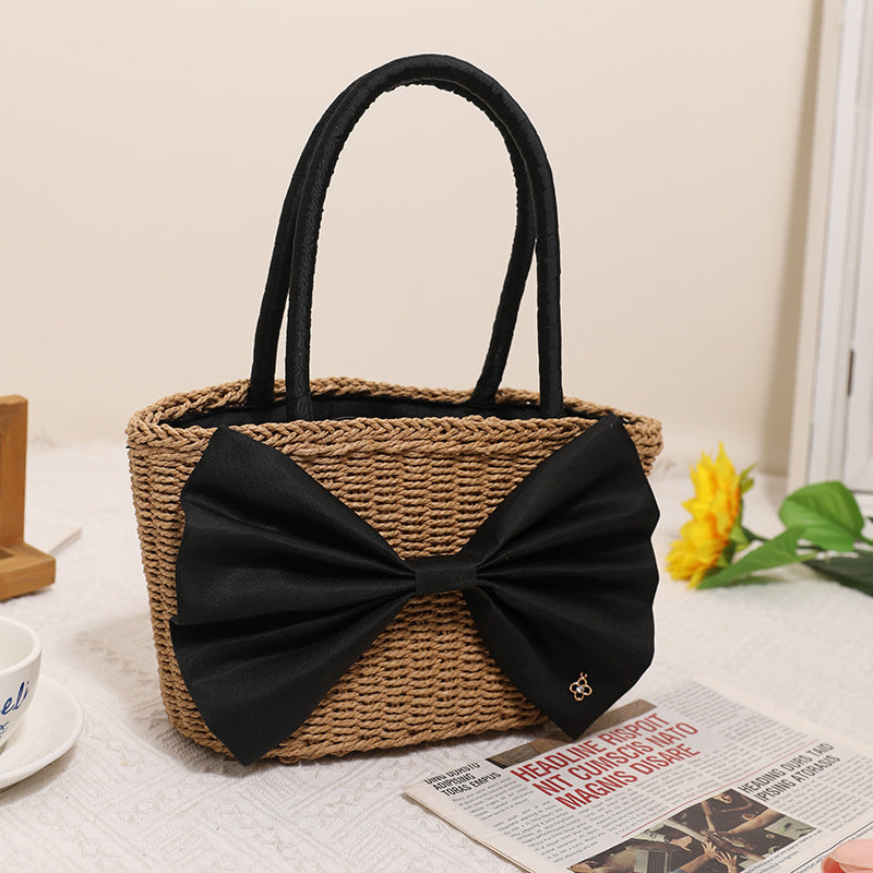 Bolso de mano tejido de paja con lazo bohemio