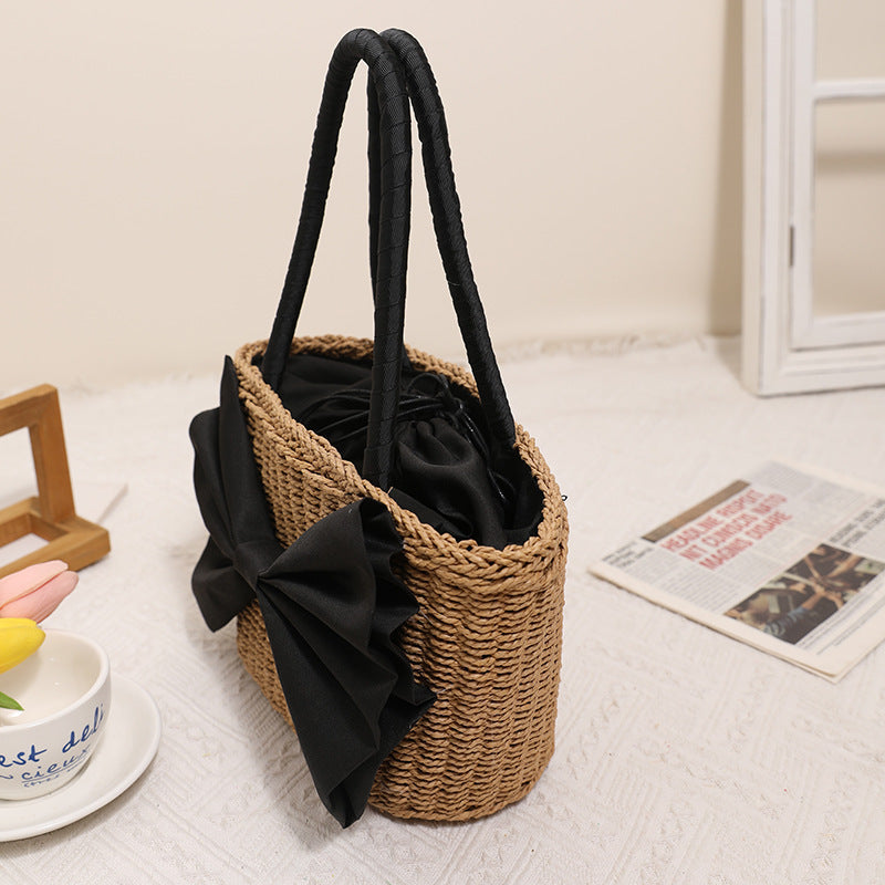 Bolso de mano tejido de paja con lazo bohemio