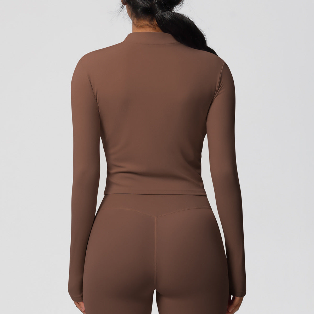 Top deportivo de manga larga de color liso a la moda para mujer