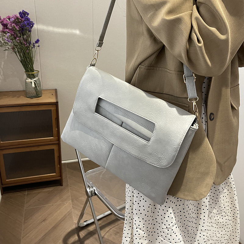 Bolso de mano tipo sobre de color liso para mujer, sencillo y moderno.