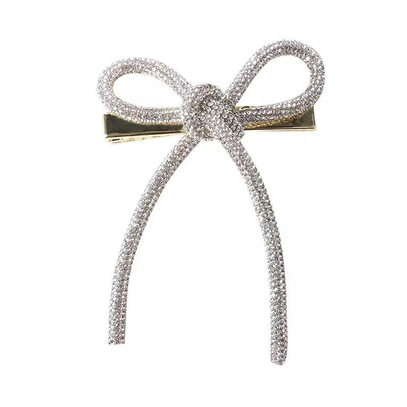 Horquilla con lazo de diamantes de imitación de color liso para mujer - Estilo aleación