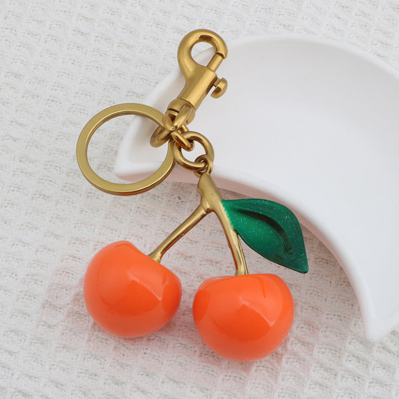 Llavero con colgante de resina con forma de cereza para bolso de mujer