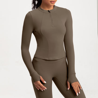 Top de yoga de manga larga con media cremallera de color liso a la moda para mujer