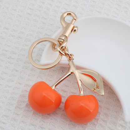 Llavero con colgante de resina con forma de cereza para bolso de mujer