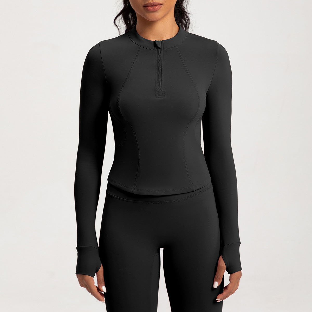 Top de yoga de manga larga con media cremallera de color liso a la moda para mujer