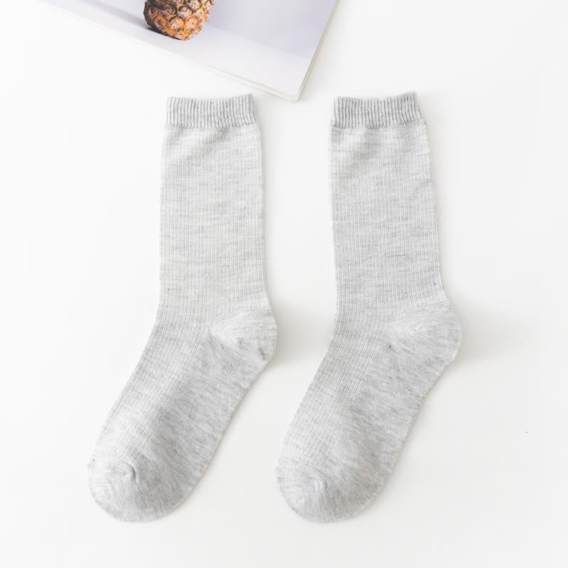 Calcetines de tubo de color liso sencillos a la moda para mujer