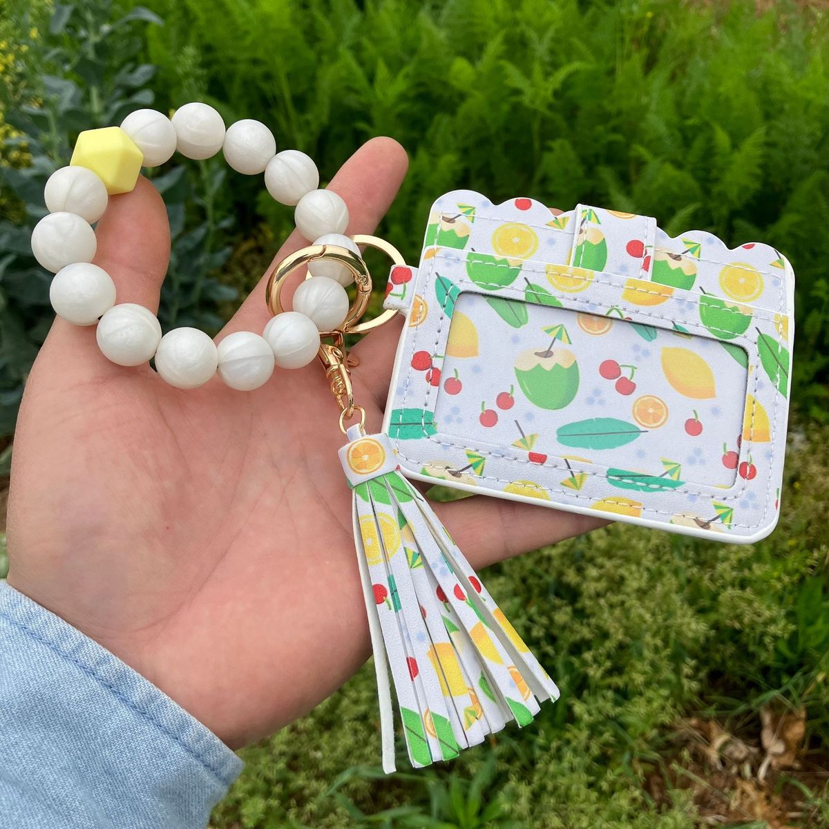 Cartera con pulsera y borlas de silicona estampadas a la moda