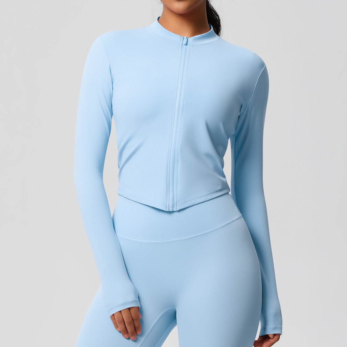 Top deportivo de manga larga de color liso a la moda para mujer