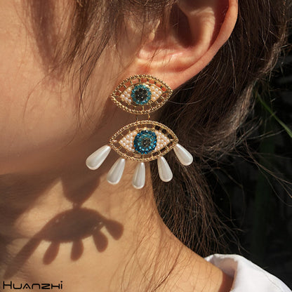 Pendientes de ojo de diablo con perlas de imitación de diamantes de imitación para mujer