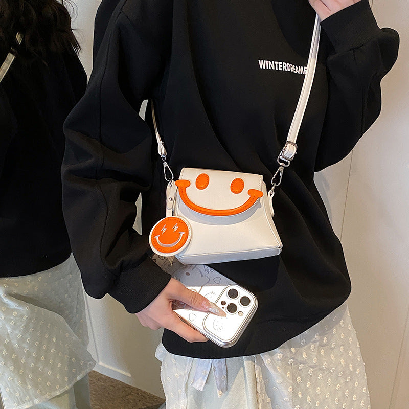 Lindo bolso bandolera mini con carita sonriente de dibujos animados