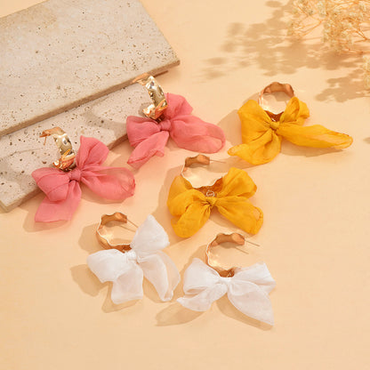Boucles d'oreilles bohèmes en cuivre avec nœud pour les fêtes