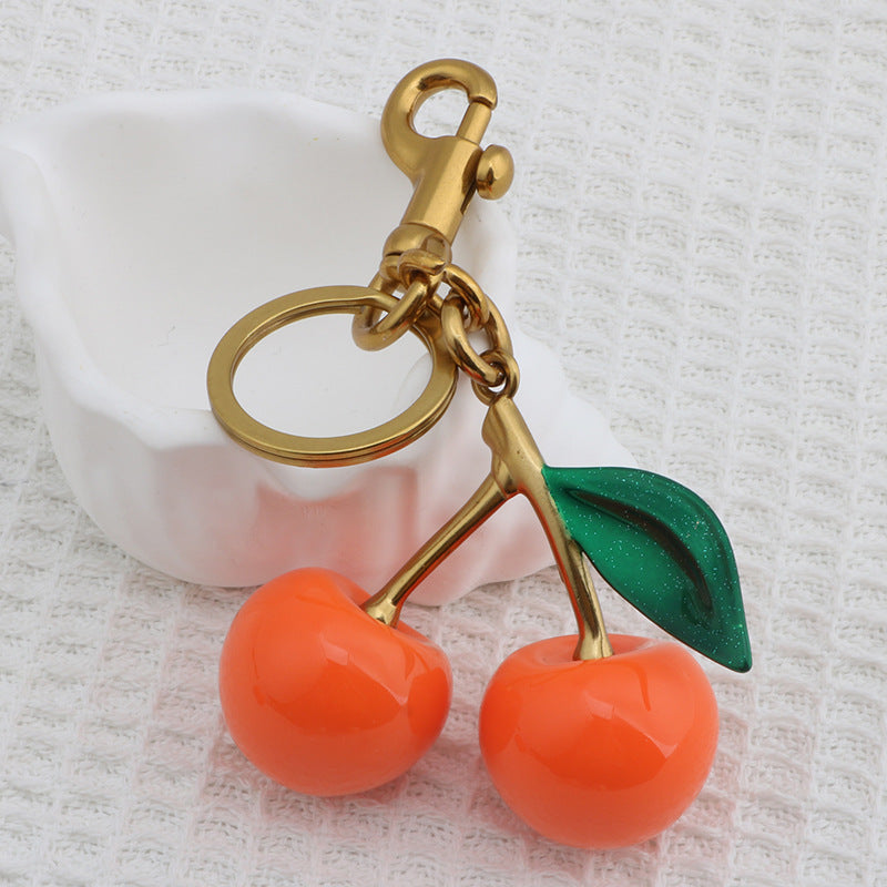 Llavero con colgante de resina con forma de cereza para bolso de mujer