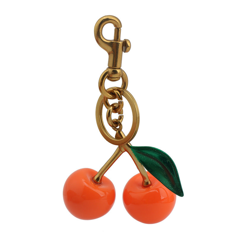 Llavero con colgante de resina con forma de cereza para bolso de mujer