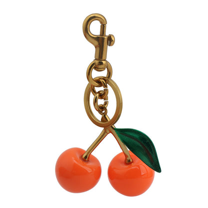 Llavero con colgante de resina con forma de cereza para bolso de mujer