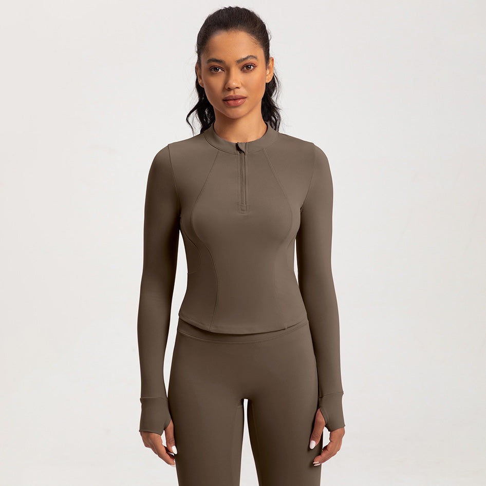 Top de yoga de manga larga con media cremallera de color liso a la moda para mujer