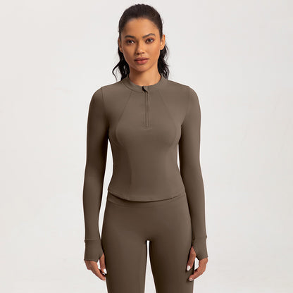 Top de yoga de manga larga con media cremallera de color liso a la moda para mujer