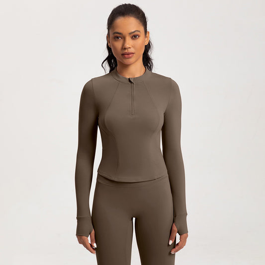 Top de yoga de manga larga con media cremallera de color liso a la moda para mujer